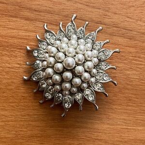 Elegant Silver and Pearl Sunburst Brooch